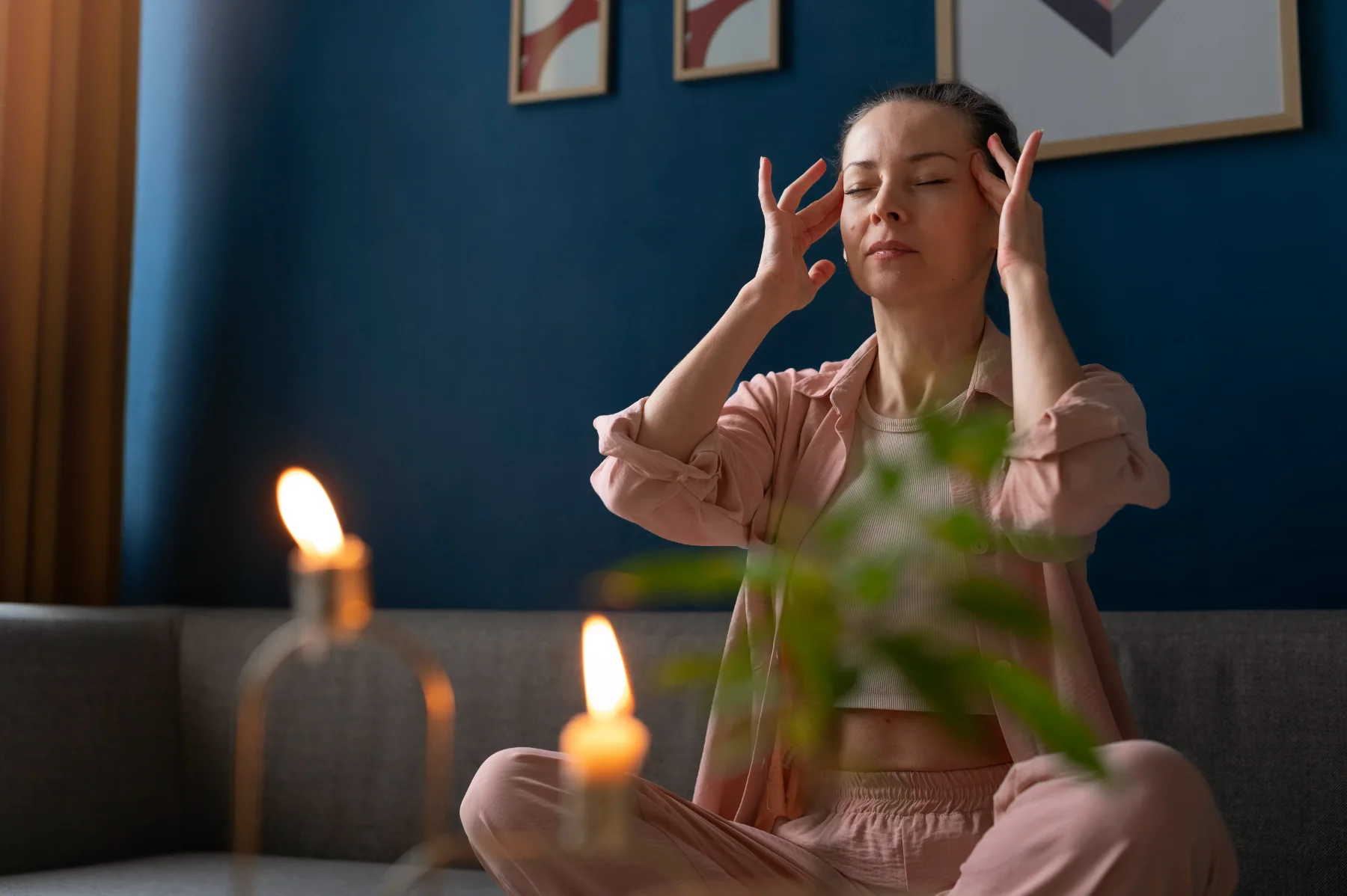 A person pausing quietly at home with eyes closed, reflecting on their own habits and patterns